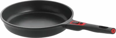 A black frying pan with a red and black handle is shown against a white background.