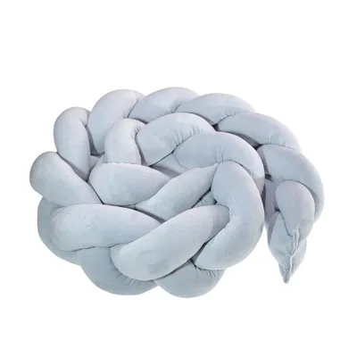A braided pillow or bumper for a baby's crib, shown against a white background.
