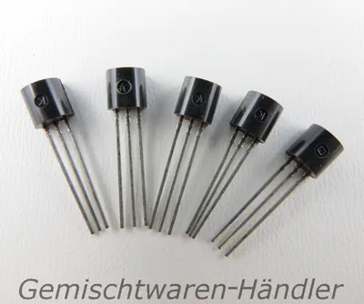Five black electronic components with three metal leads each, arranged on a white background.