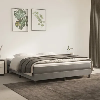 A bedroom scene with a bed, artwork, and curtains.