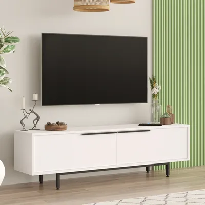 A white TV stand with a large black TV mounted above it, in a modern living room setting.