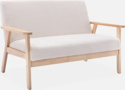 A cream-colored bouclé sofa with wooden legs is shown against a white background.