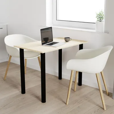 A table with two chairs in a bright, minimalist room.