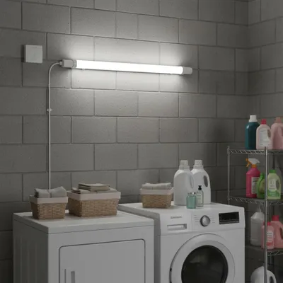 A laundry room with a washing machine, dryer, and cleaning supplies.