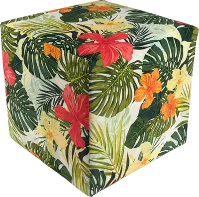 A cube-shaped ottoman with a tropical floral pattern.