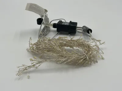 A string of fairy lights with a transformer and plug.