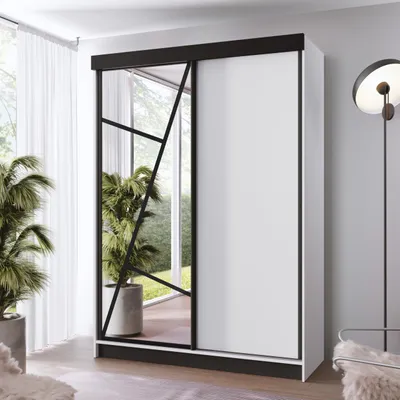 A modern sliding door wardrobe with a mirrored section, shown in a well-lit room with plants.
