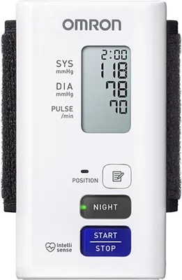A white OMRON blood pressure monitor with a digital display and buttons.