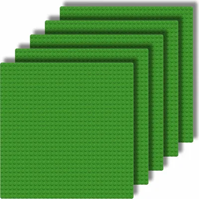 A stack of green baseplates for building blocks, arranged in a stepped pattern.