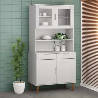 A white highboard cabinet with glass doors and wooden legs, placed against a light green tiled wall.