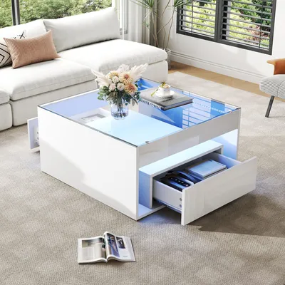 A modern living room with a white sectional sofa and a white high-gloss coffee table with LED lighting.