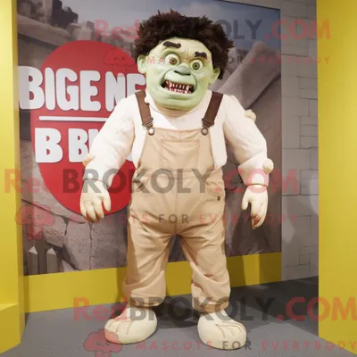 Obrázok produktu pre Maskot spoločnosti REDBROKOLY, béžové monštrum pripomínajúce Frankenšteina, oblečené v pracovných nohaviciach (džínsach) s náprsníkovými vreckami