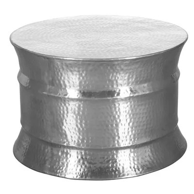 A silver, round, hammered metal side table.