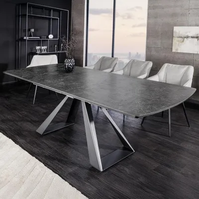 A modern dining room with a large ceramic dining table and chairs, set against a backdrop of a large window with a city view.