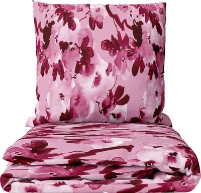 A folded duvet and a pillow with a floral pattern.