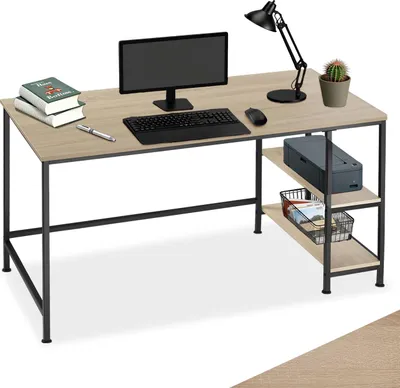 A computer desk with a monitor, keyboard, mouse, lamp, books, and a printer on shelves.