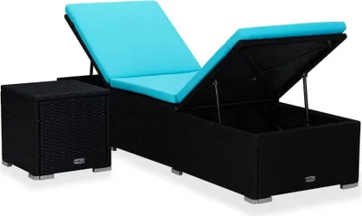 A black rattan sun lounger with a blue cushion and an open storage compartment, next to a matching black rattan side table.