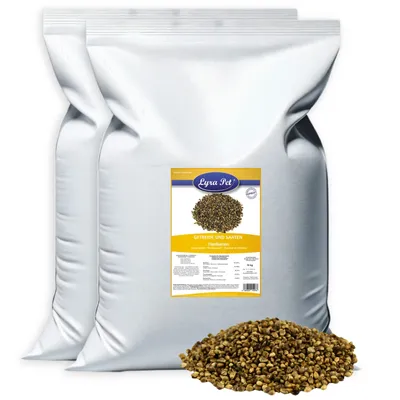 Two large white bags of pet food with a label on the front bag and a pile of the product in front of the bags.