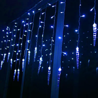 Blue icicle-shaped string lights hanging in the dark.