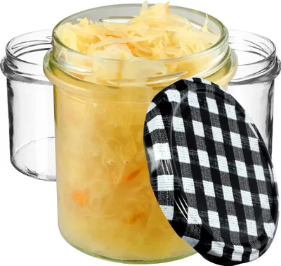Three glass jars, one filled with sauerkraut, and a checkered lid.