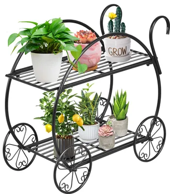 A two-tiered black metal plant stand with decorative wheels, holding various potted plants.