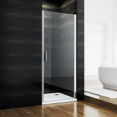 A modern bathroom with a glass shower door and a bathtub in the background.