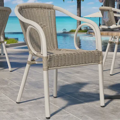 Chairs by a swimming pool with palm trees in the background.