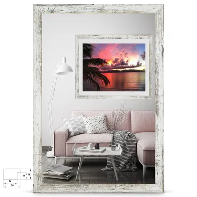 A living room scene with a pink sofa, a mirror reflecting a sunset picture, and a floor lamp.