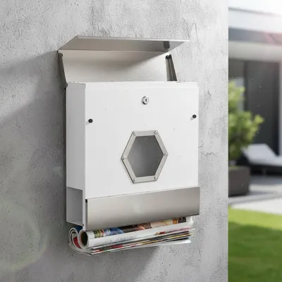 A white and silver mailbox mounted on a textured gray wall, with a newspaper compartment at the bottom.