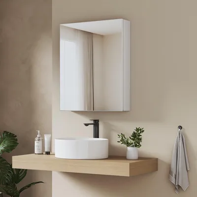 A bathroom vanity with a medicine cabinet, sink, faucet, and shelf.