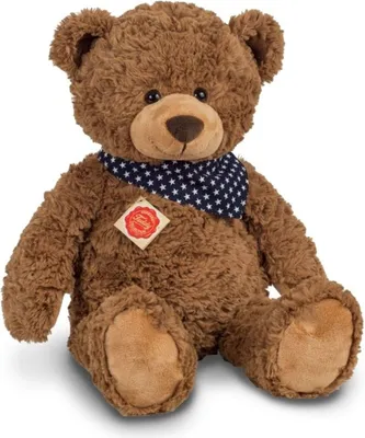 A brown teddy bear wearing a blue bandana with white stars.