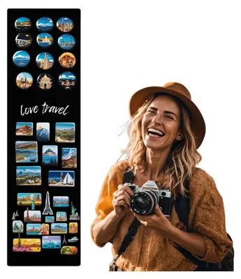A woman is laughing and holding a vintage camera, with a black panel of travel-themed magnets to her left.