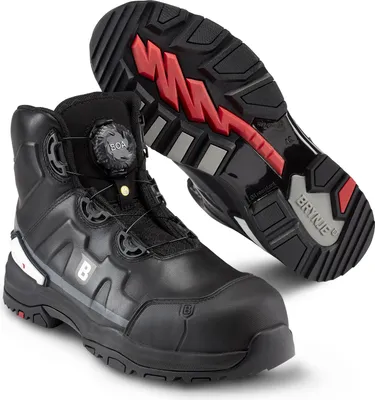 A pair of black work boots, one standing upright and the other showing its sole.