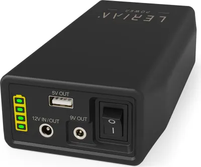 A black portable power bank with various ports and indicators.