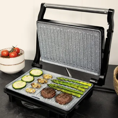 Immagine prodotto di Griglia elettrica da tavolo e sandwich maker con rivestimento RockStone in pietra, piastra superiore regolabile in altezza, vaschetta raccogli grasso e potenza di 1500 W.