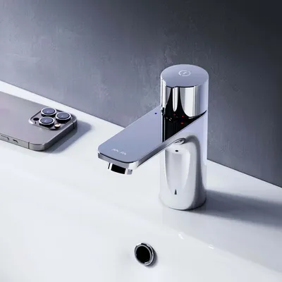 A modern chrome faucet is shown in a bathroom sink next to a smartphone.