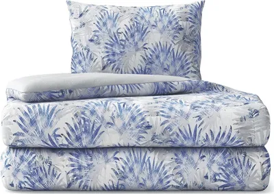 A stack of bedding with a palm leaf pattern.