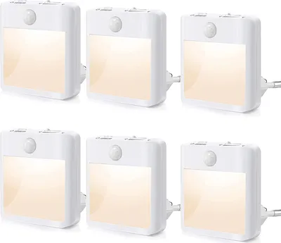 Six white LED night lights with motion sensors are arranged in two rows of three on a white background.