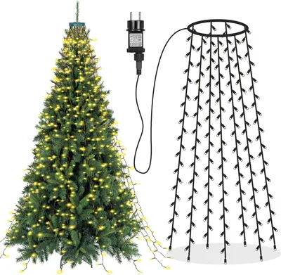 A Christmas tree decorated with string lights and a separate string of lights with a power adapter.
