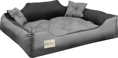 A dog bed with a raised bolster and a tufted cushion.