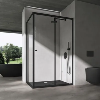 A modern bathroom with a black shower cabin, black bathtub, and black toilet, set against a concrete wall and floor.