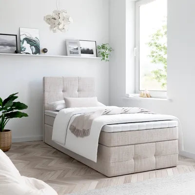 A bedroom with a bed and window.