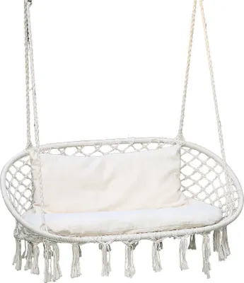 A white macrame hanging chair with beige cushions, suspended against a white background.