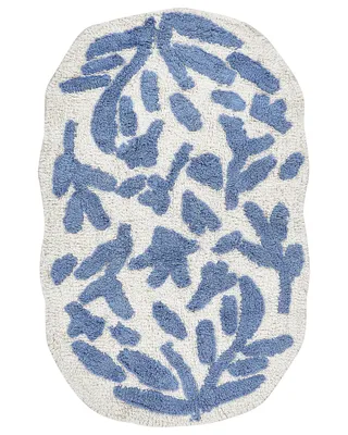 A bath mat with a blue abstract plant pattern on a white background.
