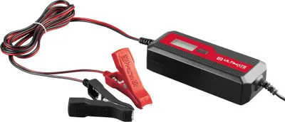 A car battery charger with jumper cables attached.