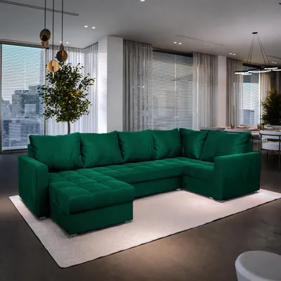 A spacious living room with a large, green sectional sofa.