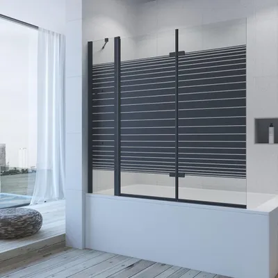 A modern bathroom with a bathtub and a shower screen.