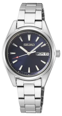 A close-up studio shot of a silver Seiko watch with a dark blue dial.