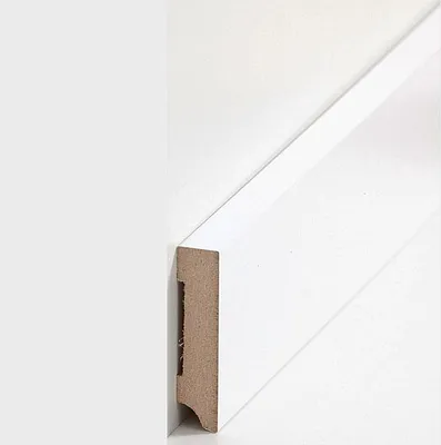 A close-up view of a white baseboard molding, showing its profile and material.