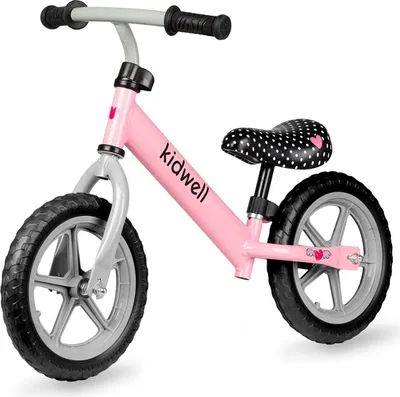 A pink Kidwell Rebel balance bike with black and white polka dot seat and black handlebars, shown against a white background.